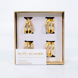 Set de servilleteros de anillos dorados en metal inoxidable, diseño elegante para decoración de mesa.