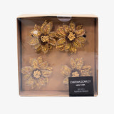 Set de servilleteros dorados en forma de girasol, diseño bordado en pedrería elegante para decoración de mesa.