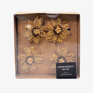 Set de servilleteros dorados en forma de girasol, diseño bordado en pedrería elegante para decoración de mesa.