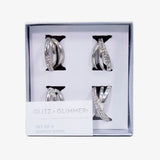 Set de servilleteros de anillos plateados en metal inoxidable, diseño elegante para decoración de mesa.